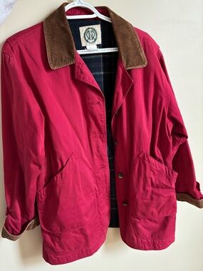 Red and brown long barn style outdoor jacket with plaid interior